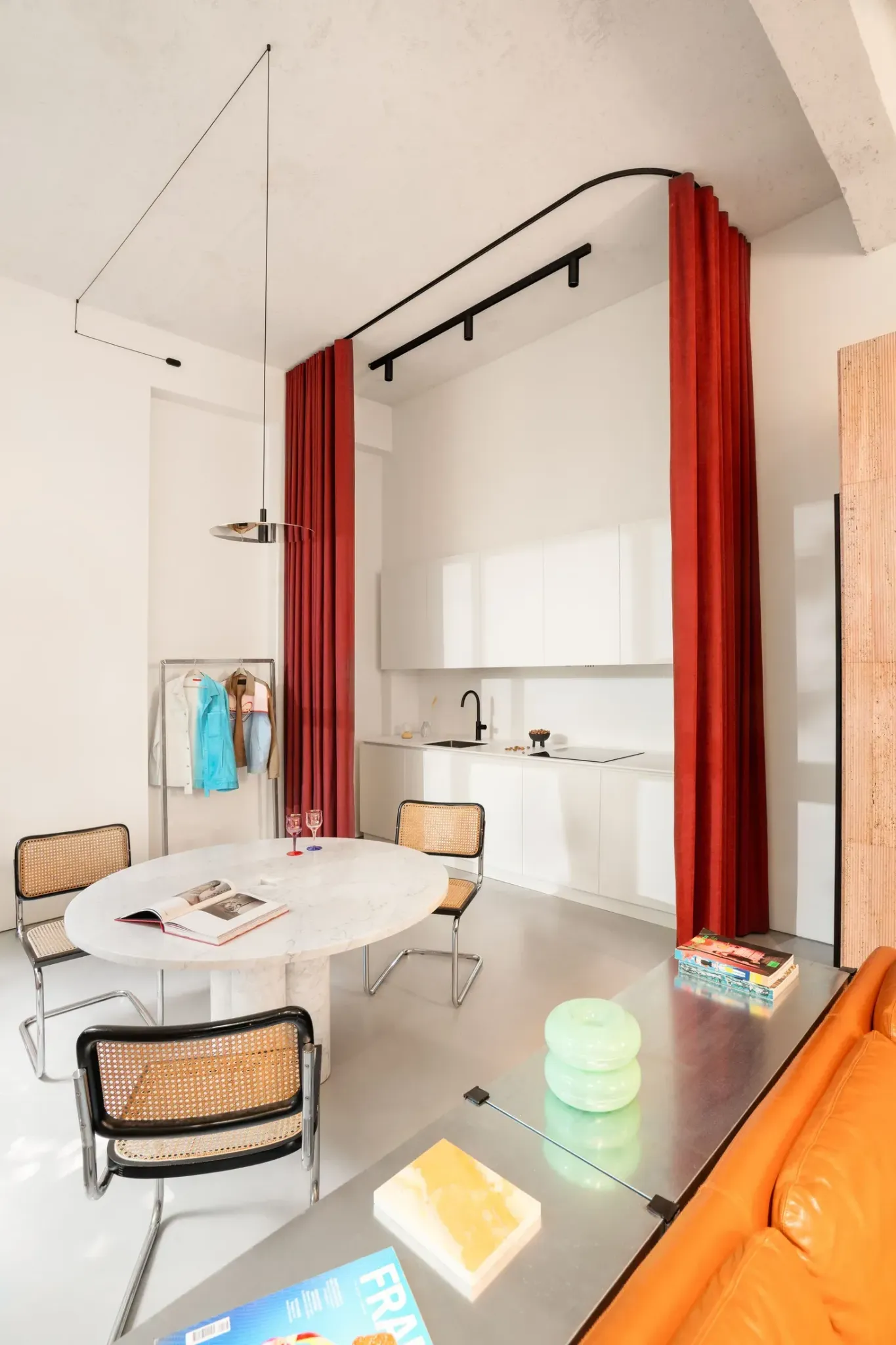 Кухня скрытая за красной шторой в интерьере 5 Bold Design Ideas Inside a Small Milan